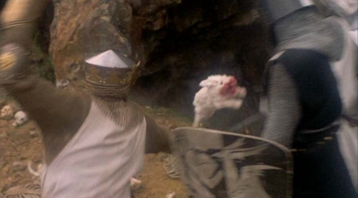 White fluffy bunny with red, blood soaked mouth attacking two knights from a scene in the movie, The Holy Grail.